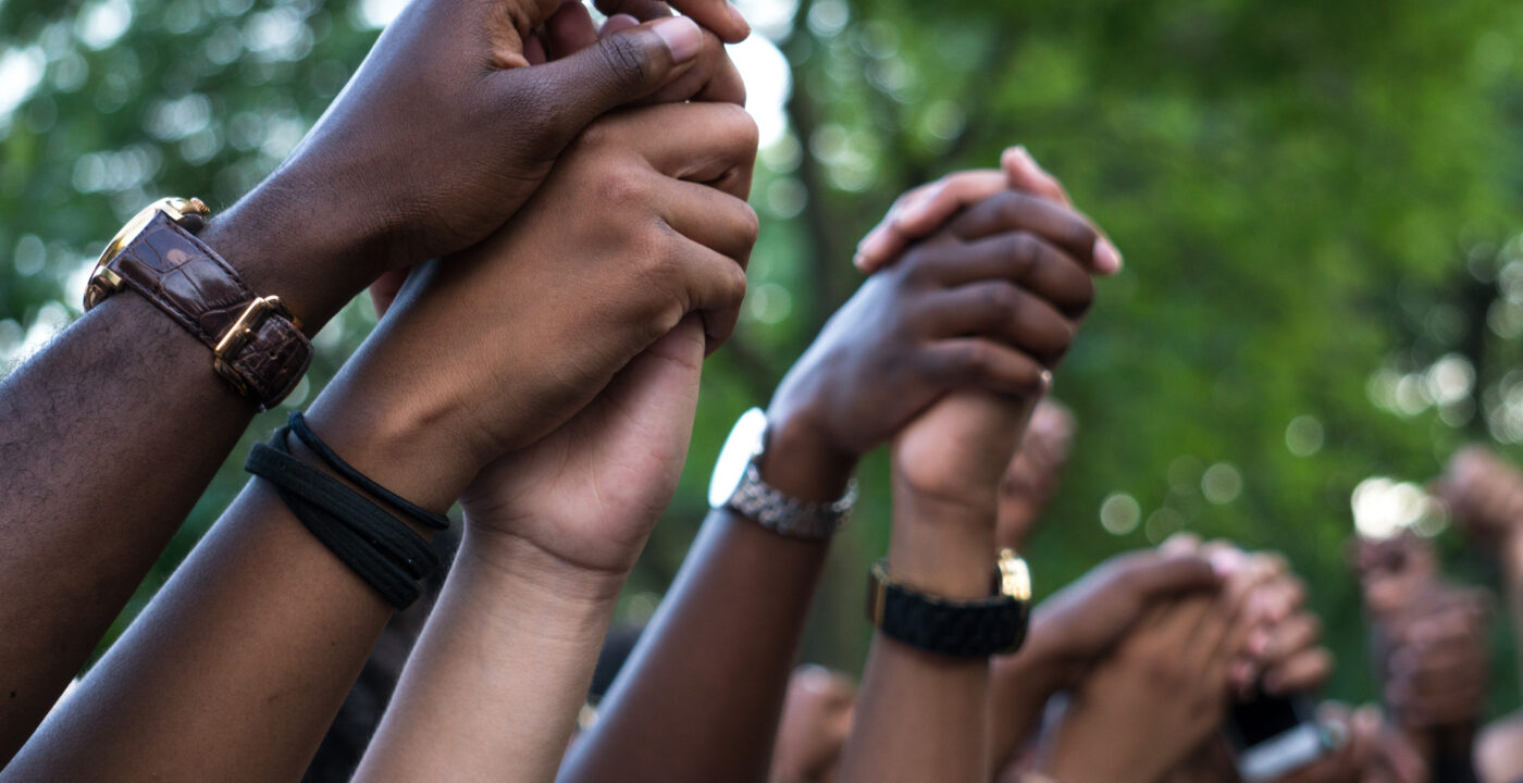 Hands raised in the hair holding other hands