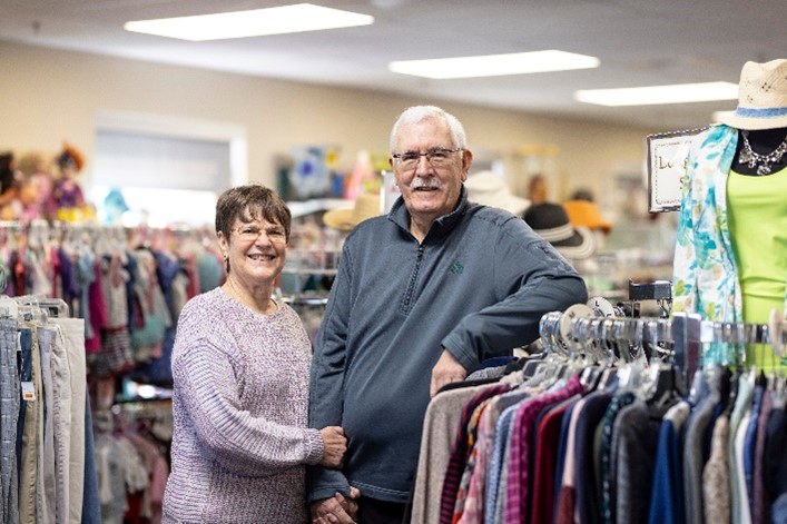 Two adults smiling in a store