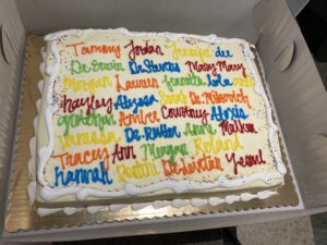 A cake with peoples names on it.