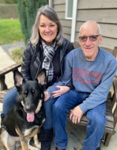 Older woman and man sitting with a dog