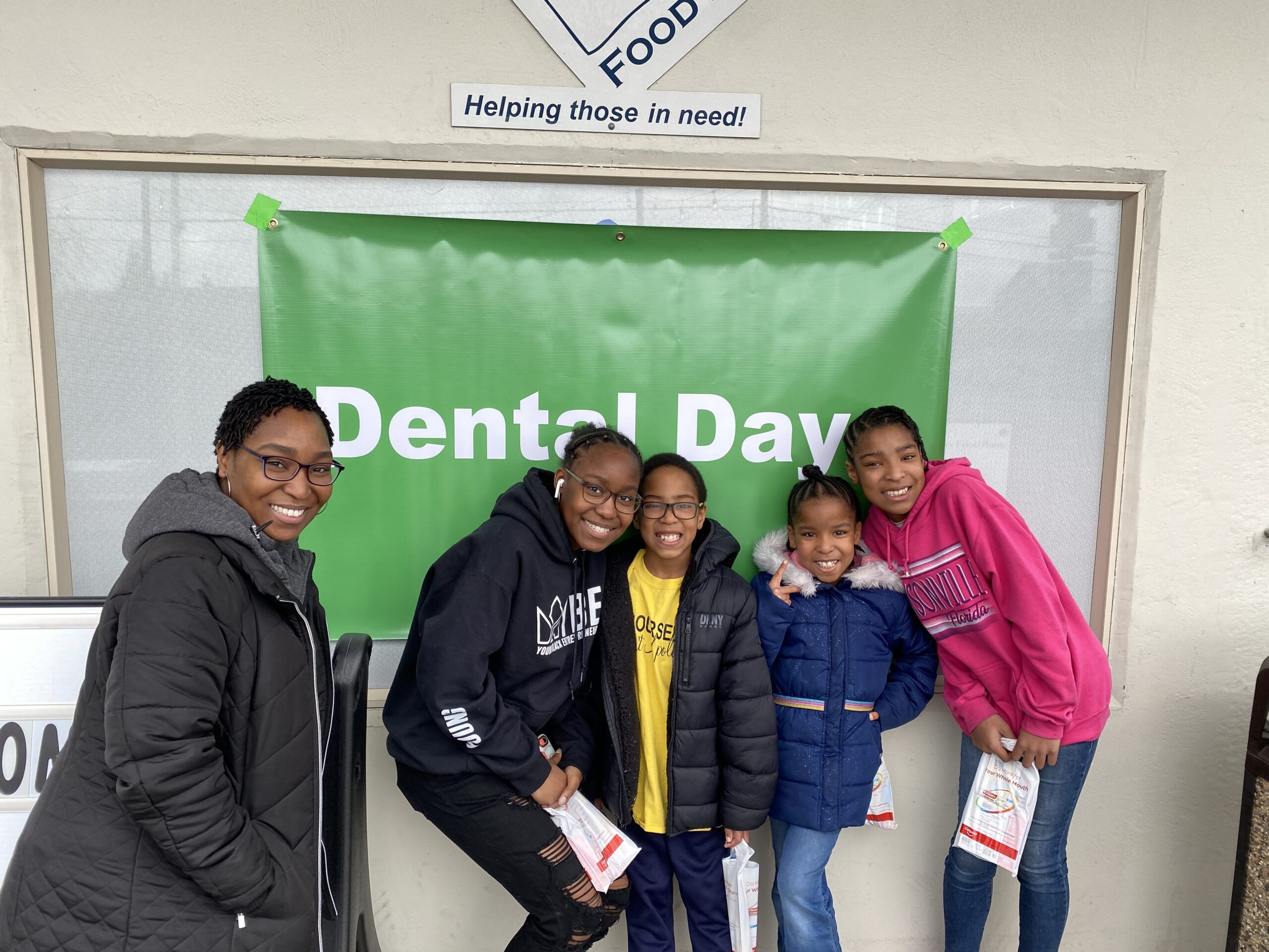 A mom and her four children stand outside the free dental clinic at Sumner Community Food Bank