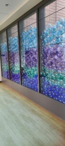 A glass wall filled with multicolored glass balls