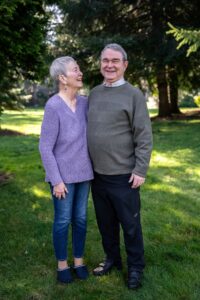 Man and woman posing in a yard.