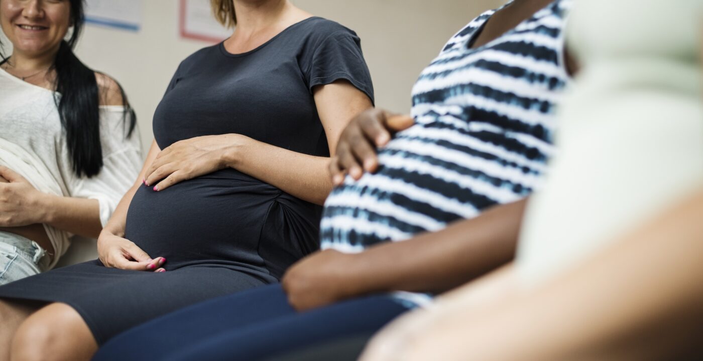 Group of pregnant women sitting next to each other