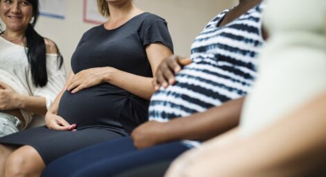 Group of pregnant women sitting next to each other