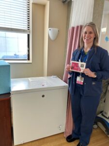 MultiCare Deaconess, woman poses for photo next to refrigerator,