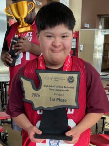 Julian smiling and showing off his Washington State Championship Basketball award