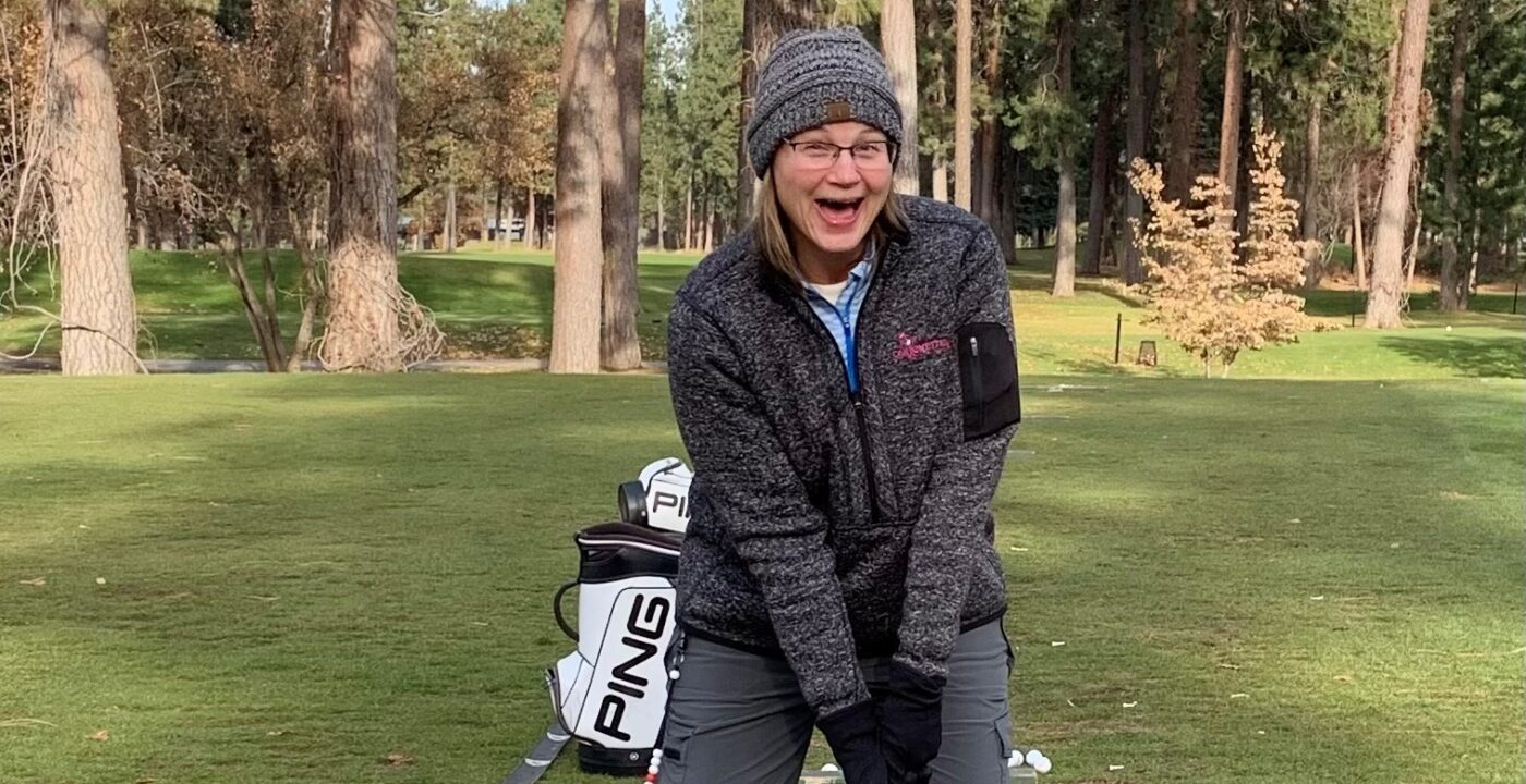Happy woman playing golf