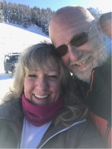 closeup of woman and man with snow in background