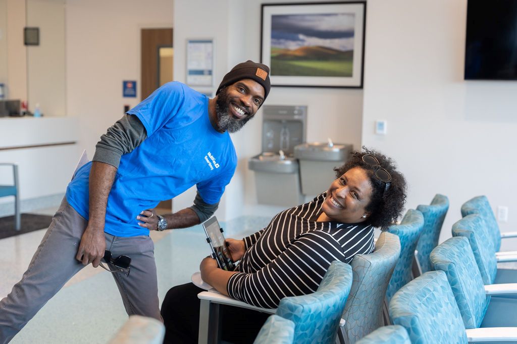 An employee and a patient in an emergency room waiting area