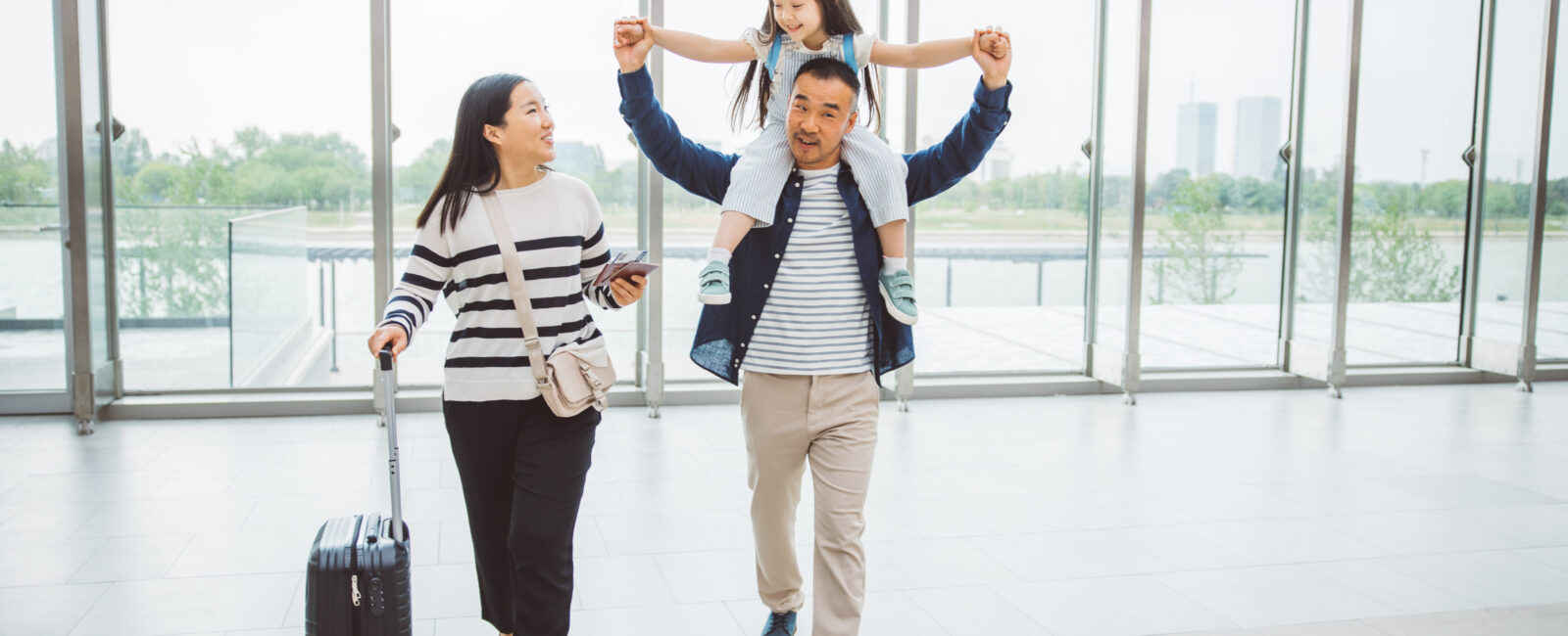 A mother, father and child at the airport