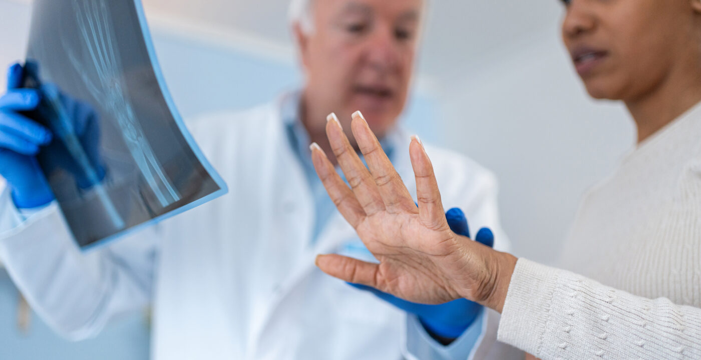 doctor reviews hand xray with patient