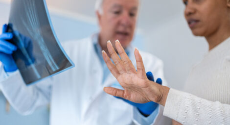 doctor reviews hand xray with patient