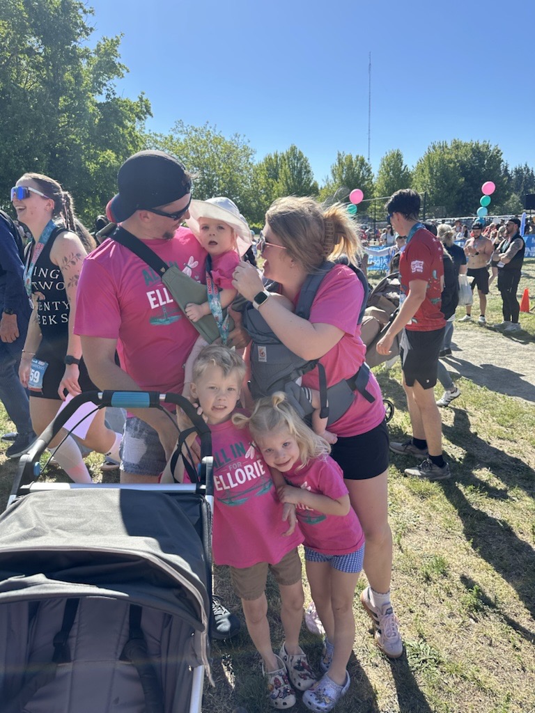cross family, man, woman and four kids pose for photo in matching shirts