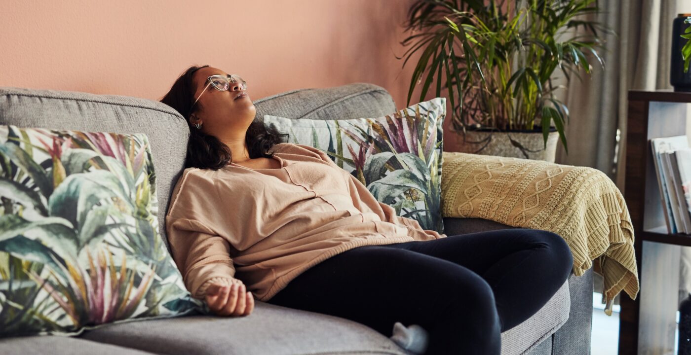 Shot of a young woman resting on the sofa at home