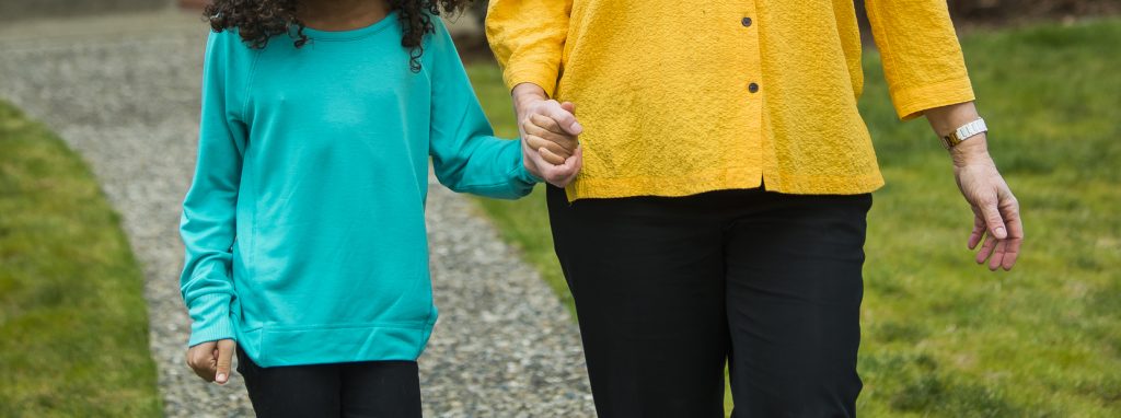 Grandma and granddaughter holding hands