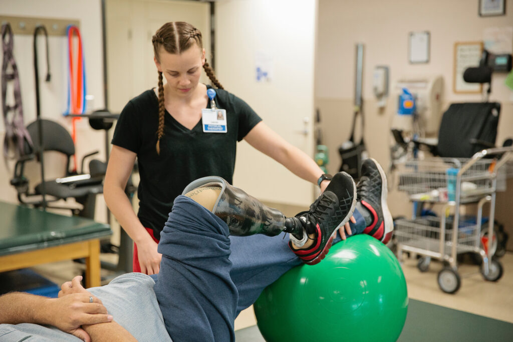 Physical therapist working with amputee