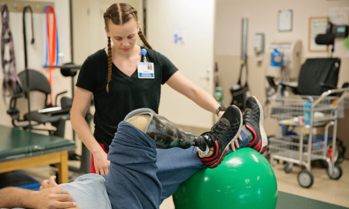 Physical therapist working with amputee