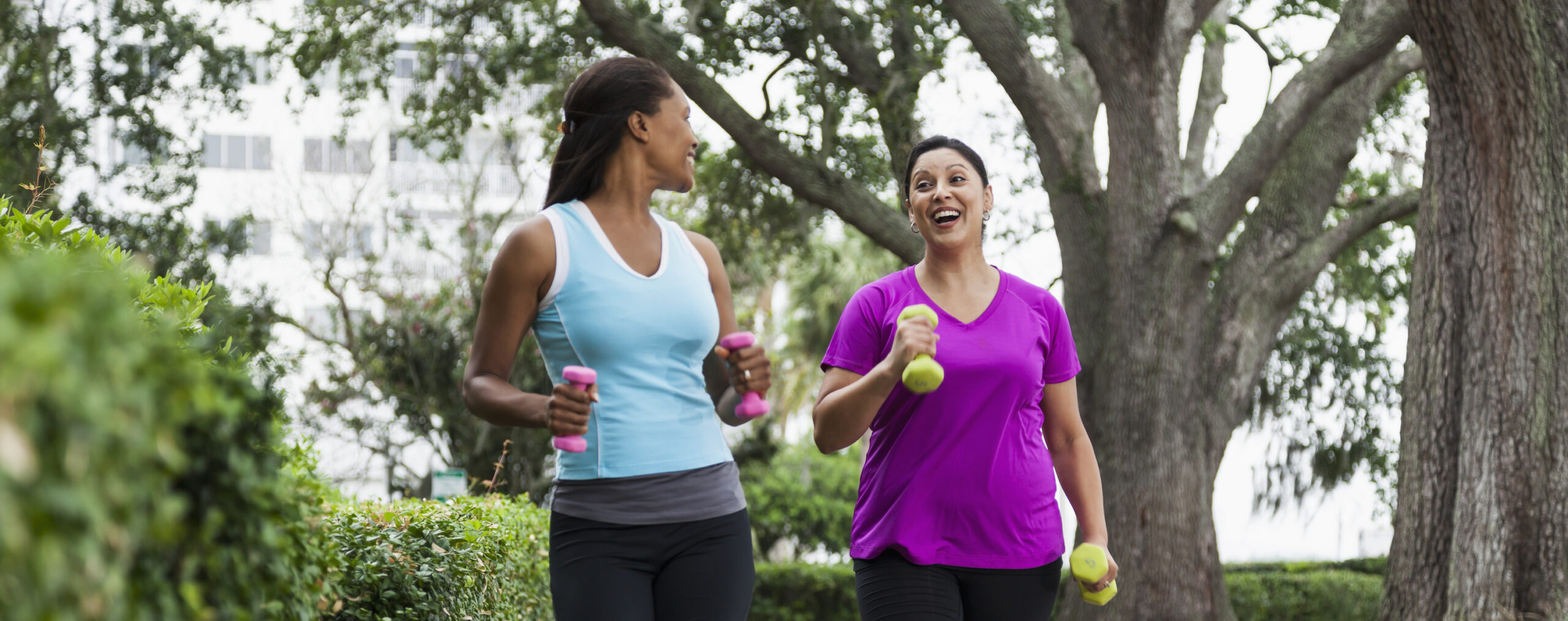 women exercising in park, power walking.