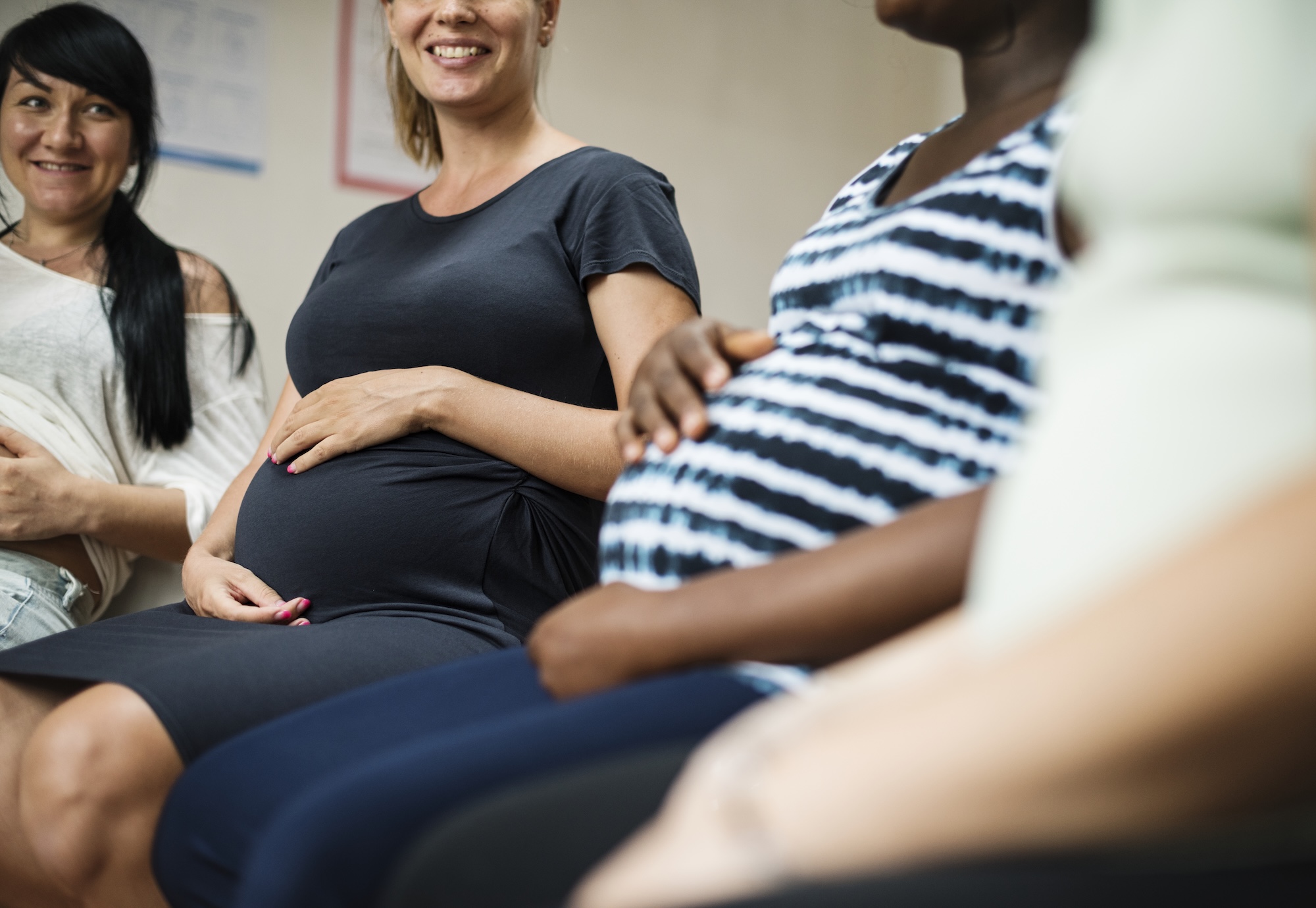Group of pregnant women sitting next to each other