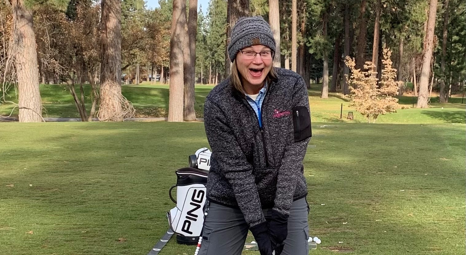 Happy woman playing golf