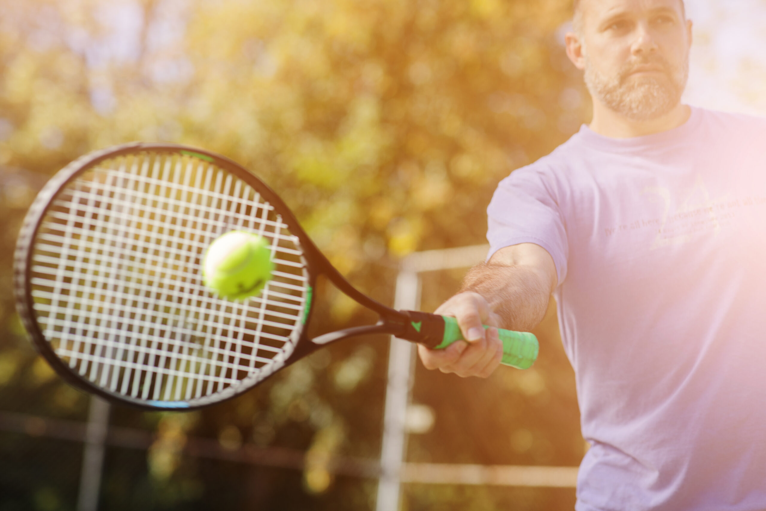 man hitting ball with tennis racket