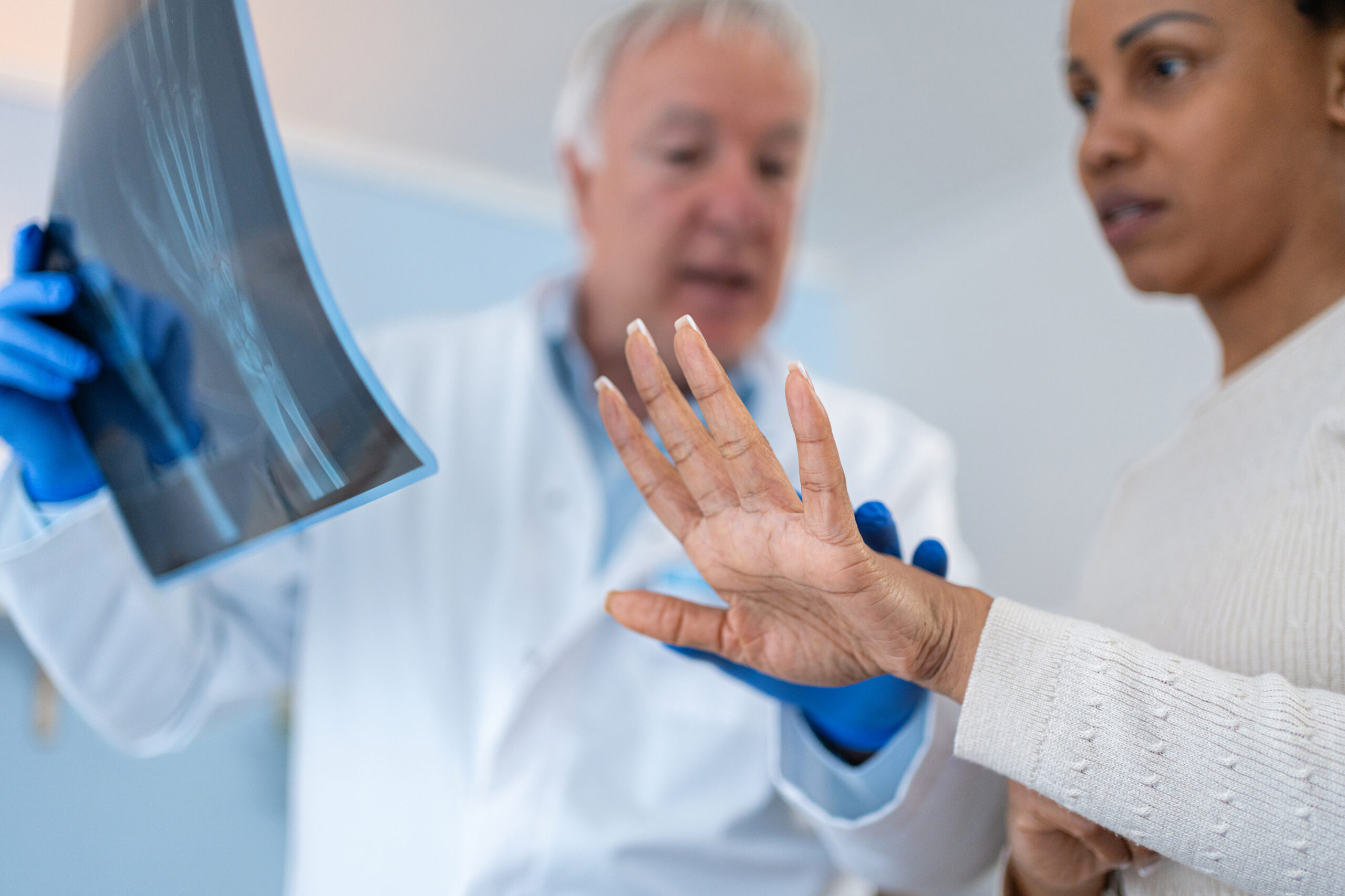 doctor reviews hand xray with patient